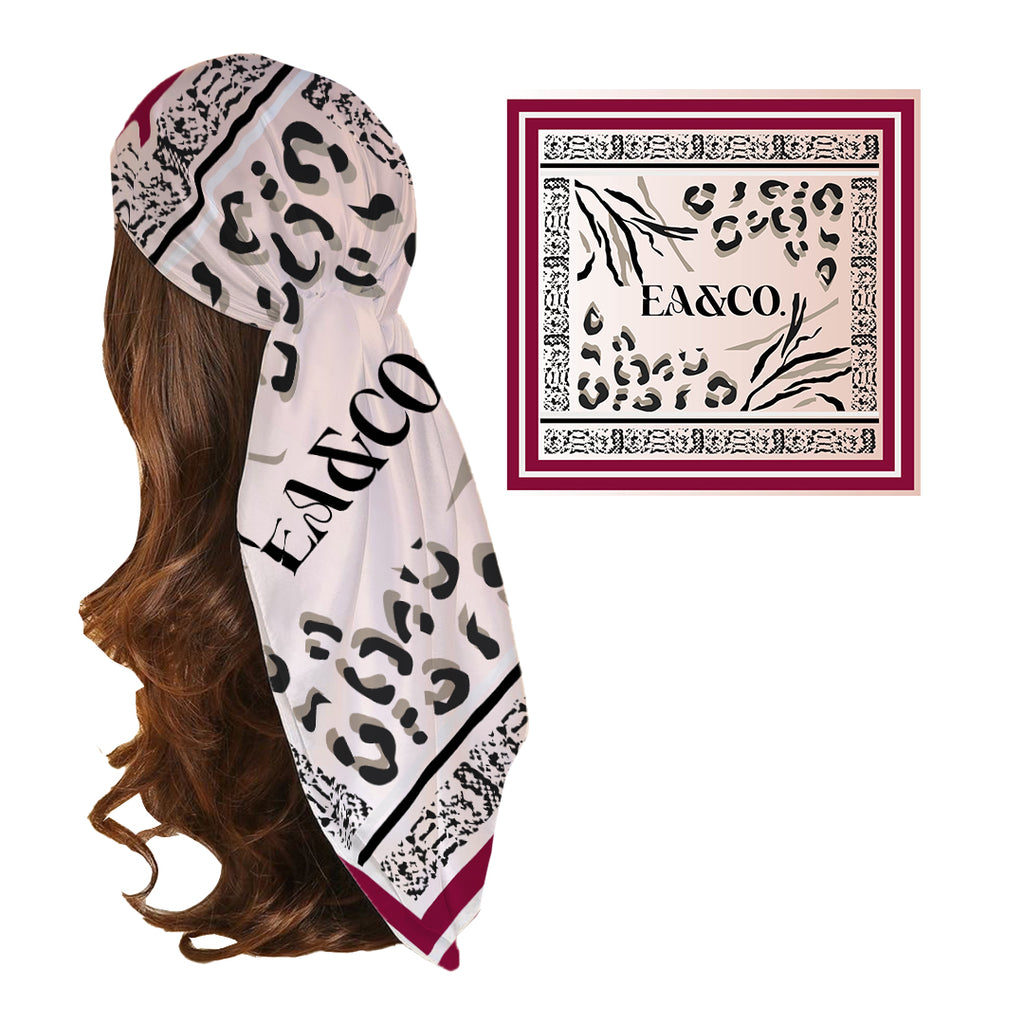 A silk headscarf with a leopard, zebra, and snake skin pattern, predominantly white with black and gray accents, and the brand name 'FAÉCO' printed on it.