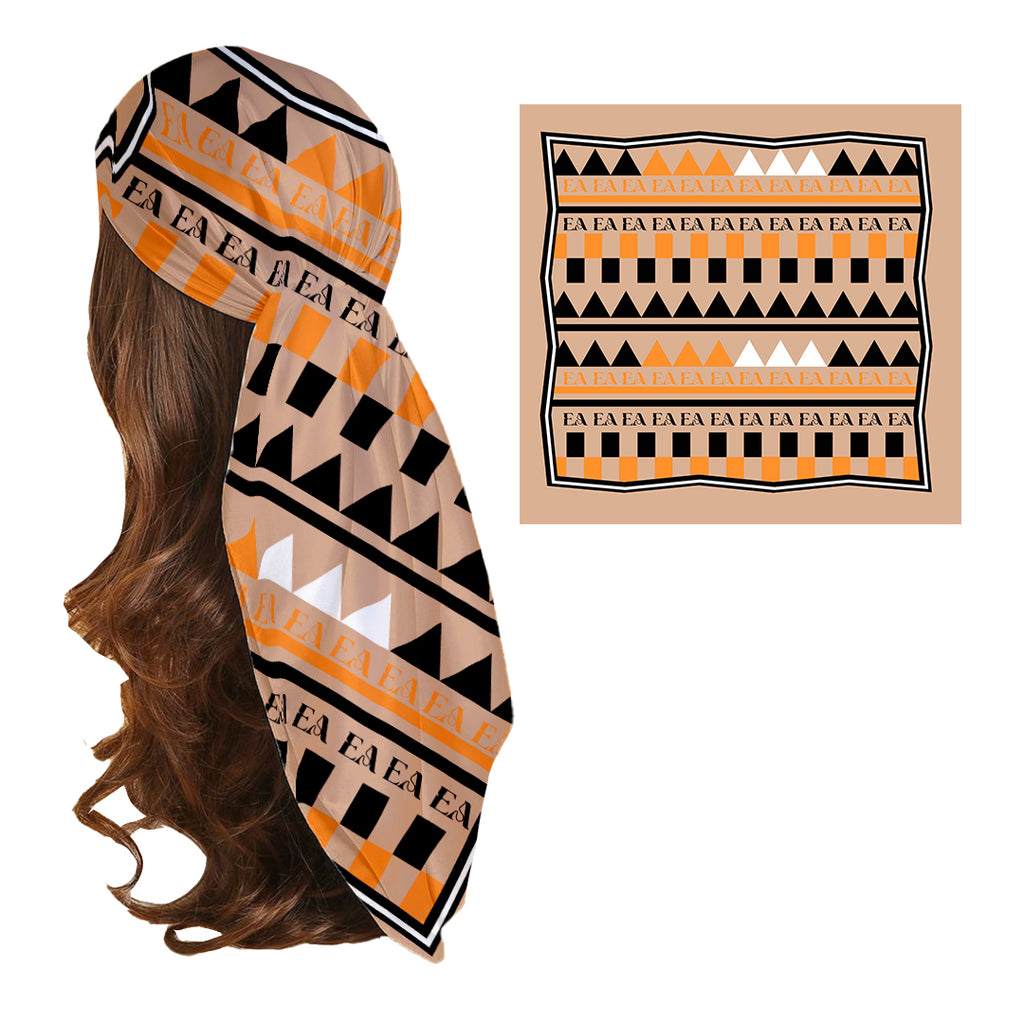 A silk headscarf with a geometric pattern featuring brown, black, and white colors, draped over a mannequin with a visible orange and white design on the fabric.